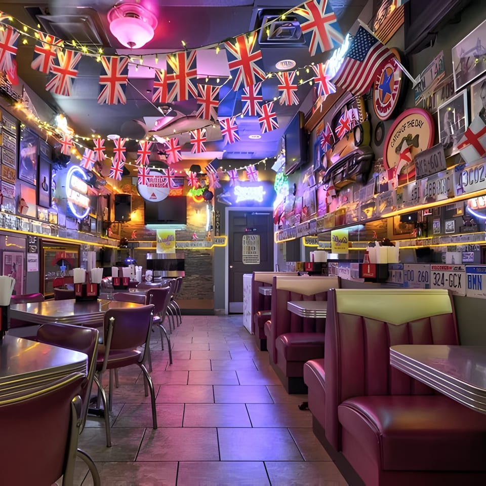 Interior of Sunday's Grill with British flag bunting, neon signs, and red diner booths.